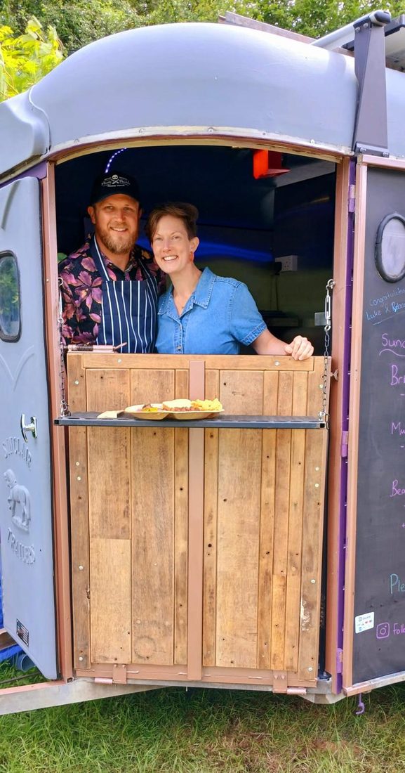 Matt and Kara at the serving window of the Bear Pit horsebox